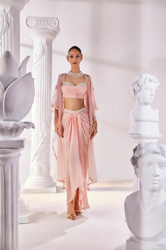 Peach Draped Skirt In Satin Georgette Paired With A Belt And A Pearl Detailed Blouse With A Soft Organza Cape. Stylish Wrap Blouse